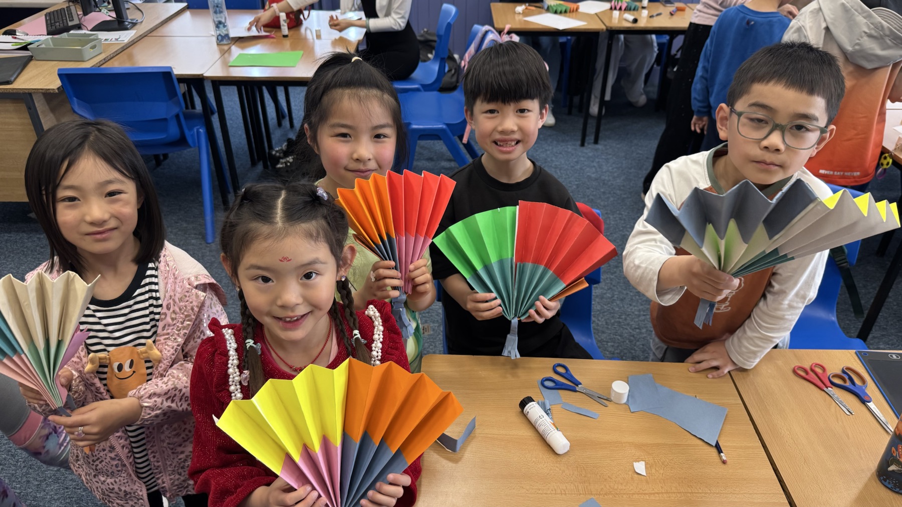 Children presenting their handmade paper fans