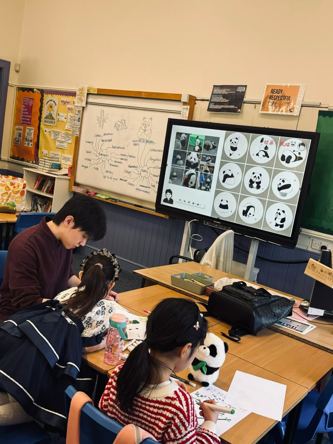 Vince supporting pupils during an art lesson